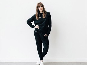 A model wears the "Brunette" chain stitch hoodie and jogger pants from the Vancouver-based brand BRUNETTE the Label.