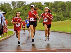 Dr. Shaunna Taylor, a mental performance consultant and co-chair of the Canadian Sport Psychology Association and executive director of the PacificSport Okanagan Sport Centre, runs with her daughter Skylar, left.