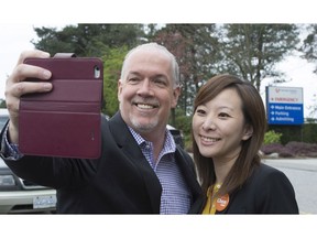B.C. NDP leader John Horgan takes a selfie with candidate Katrina Chen following a media availability outside Burnaby Hospital on Tuesday.