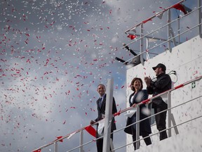 Confetti floats in the air after British Columbia Premier Christy Clark, centre, released a bottle of champagne as Jonathan Whitworth, left, interim CEO of Seaspan Shipyards, and Kyle Washington, right, Executive Chairman of Seaspan, watch during a commissioning ceremony for two new Seaspan LNG-fuelled vessels in Delta, B.C., on Sunday April 9, 2017. A provincial election will be held on May 9.