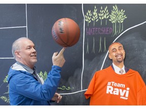B.C. NDP leader John Horgan plays with a basketball while visiting NDP candidate Ravi Kahlon's campaign headquarters in North Delta on Monday, April, 10.