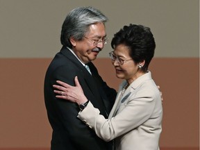Former chief secretary Carrie Lam, right, smiles as she's congratulated by her rival candidate, former financial secretary John Tsang, after winning the chief-executive election in Hong Kong on March 26.