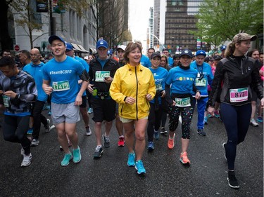 Liberal Leader Christy Clark, centre, jogs to the start line to participate in the Sun Run in Vancouver, B.C., on Sunday April 23, 2017. A provincial election will be held on May 9.