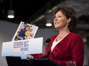 Former premier and B.C. Liberal leader Christy Clark unfolds her party's election platform at an April 10 news conference in Vancouver.