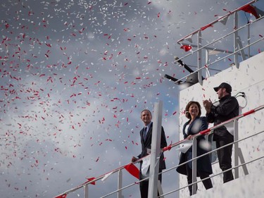 Confetti floats in the air after British Columbia Premier Christy Clark, centre, released a bottle of champagne as Jonathan Whitworth, left, interim CEO of Seaspan Shipyards, and Kyle Washington, right, Executive Chairman of Seaspan, watch during a commissioning ceremony for two new Seaspan LNG-fuelled vessels in Delta, B.C., on Sunday April 9, 2017. A provincial election will be held on May 9.