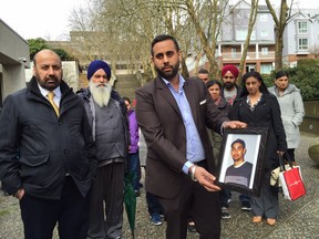 Cousin Harpreet Khela and family holds photo of Amandeep Bath. Kim Bolan  [PNG Merlin Archive]