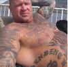 Donnie Lyons with his IS tattoo on his right side