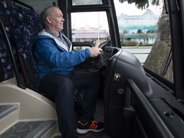 British Columbia NDP Leader John Horgan sits behind the wheel of his campaign bus in North Delta, B.C, Monday, April, 10, 2017.