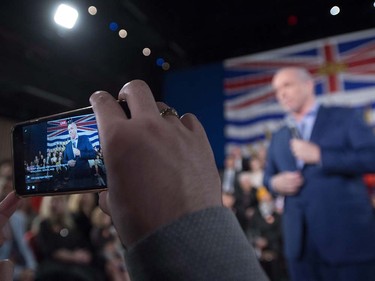 NDP Leader John Horgan is filmed on a smart phone by a supporter as he addresses a campaign gathering in Vancouver, Tuesday, April, 11, 2017.