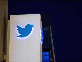 (FILES) This file photo taken on November 4, 2016 shows the Twitter logo  on a sign at the company's  headquarters in San Francisco, California.  The US government dropped its effort to force Twitter to identify the owner of an anti-Trump account purported to voice dissent from federal employees, court documents showed on April 7, 2017. In a court filing, Twitter sought the dismissal of the lawsuit it had filed just a day earlier that claimed the government had overstepped its authority in seeking to unmask the account owner. /