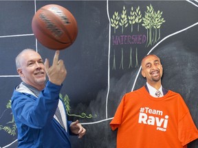 British Columbia NDP Leader John Horgan plays with a basketball while visiting NDP candidate Ravi Kahlon's campaign headquarters in North Delta on Monday.