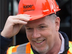 NDP Leader John Horgan puts on a hard hat during a campaign stop at the International Union of Operating Engineers Local 115 Training Centre in Maple Ridge.