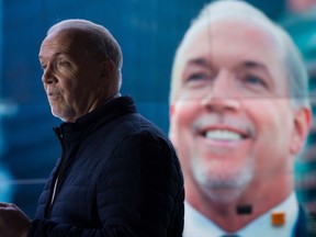 NDP Leader John Horgan speaks as a photo of himself is seen on his bus during a campaign stop at the International Union of Operating Engineers Local 115 Training Centre in Maple Ridge, B.C., on Tuesday April 18, 2017. A provincial election will be held on May 9.