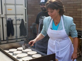 Liberal Leader Christy Clark in her home riding of Kelowna West flips pancakes at an Easter breakfast event.