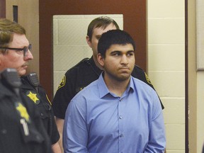 In this Sept. 26, 2016, file photo, Arcan Cetin is escorted into Skagit County District Court by Skagit County's Sheriff's Deputies, in Mount Vernon, Wash. News reports say that Cetin, who was charged with shooting and killing five people at a mall in Washington state in September, has been found dead in his jail cell. KING-TV reports that the Skagit County Prosecutor's Office said Cetin was found hanging in his cell just before 9 p.m. Sunday, April 16, 2017.