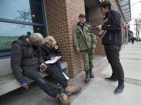 Homeless count volunteers Karen (surname withheld), second from left, and Jeremy Hunka, right, collect information from homeless people in downtown New Westminster last month, the day the once-every-three-years survey was conducted across Metro Vancouver.