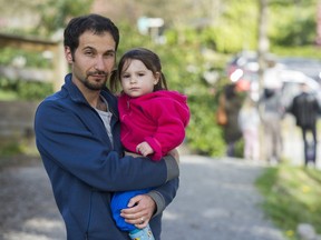 Michael Gerzon, holding his daughter Bianca, has two children in Junior Citizens daycare who may be affected by the closure of part of the daycare at Mountain Meadows elementary in Port Moody,