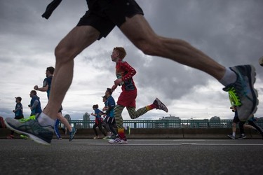 Runners cross the Cambie Bridge during the Sun Run in Vancouver, B.C., on Sunday April 23, 2017.