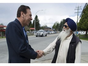 The B.C. NDP candidate in the riding of Surrey-Fleetwood, Jagrup Brar, greets a voter outside Coyote Creek elementary school in Surrey.