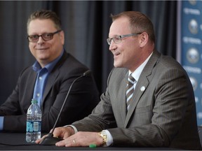 Buffalo Sabres general manager Tim Murray, left, looks on as the Sabres new coach Dan Bylsma speaks during an NHL hockey news conference, Thursday, May 28, 2015, in Buffalo, N.Y.