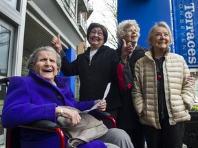 Phyllis Burt holds her letter from the Terraces on 7th owner saying she and other elderly residents will be able to stay in their subsidized assisted-living suites — at current fees. Burt and fellow residents Rose Naguib, June Evans and Martine Donahue (standing, left to right) are happy and relieved by this week’s news.