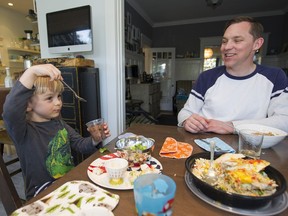 Nolan Tupper is poised to dig into his desert as his father Bryce looks on in bemusement. The Tupper family uses Eat Your Cake, one of about a dozen Vancouver startups that shop for food, prepare meals and deliver them, ready to eat, to your door.