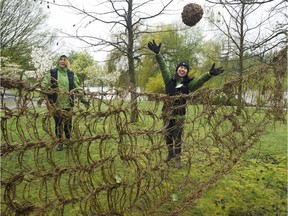 Volunteers with the Stanley Park Ecology Society play a game of absurdist volleyball, using a net and ball woven from English ivy, at Earth Day festivities at the park in Vancouver on Saturday.