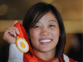 Canadian wrestler Carol Huynh shows off her gold medal from the 2008 Beijing Olympic Games.