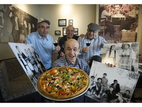 Four of the six Kerasiotis brothers from Olympia Pizza - left to right, Peter, Jim, George (with pizza) and Nick.