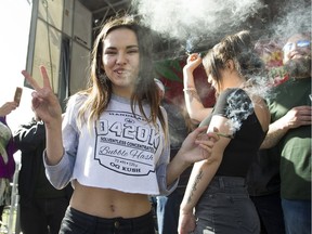 Lighting it all up - Joint toss members show how it's done as hundreds took part in the annual "4/20 celebration" and smoke up in front of Sunset beach in Vancouver on April 20, 2017.