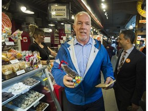 B.C. NDP Leader John Horgan buys a chocolate bunny as he visits Lonsdale Quay on Wednesday in North Vancouver, B.C., April 12, 2017.