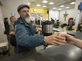 Mike Gosling hands out coffee during his volunteer shift at the Union Gospel Mission Easter dinner in Vancouver on Saturday.