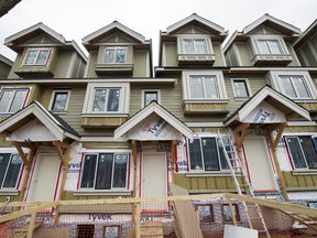 Townhouses under construction on East Broadway at St. Catherines Street in Vancouver are an example of the types of housing that should have higher priority, a report says.