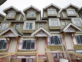 FILE PHOTO - Housing under construction on East Broadway at St. Catherines in Vancouver, B.C., April 17, 2017.