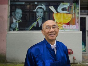 Fred Mah, committee chair for Celebrate Vancouver Chinatown's Heritage, stands in front of a photo at E. Pender near Columbia streets in Vancouver on Wednesday. Its one of the first heritage windows featuring a remarkable image of Wong Foon Sien, the unofficial Chinatown mayor and rights activist, sharing a meal with African-American singer and actress Lena Horne.