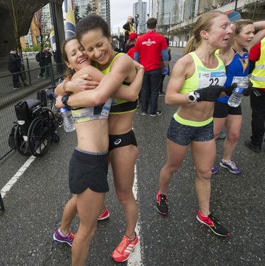 Shauna Gersbach (left) and Katherine Moore hug as about 40,000 runners competed in 2017 Vancouver Sun Run in Vancouver, B.C., April 23, 2017.