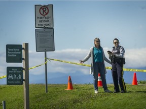 Police block the trail and the road after a body was found in the 2800-block River Road in Richmond, B.C., April 24, 2017.