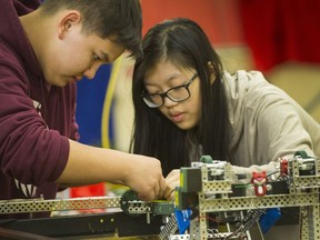 Matthias Bernhard and Denise Chan work on a robot at Gladstone Secondary School in Vancouver on Tuesday. A team from the school is going to the robotic world championships in Louisville, Ky., later this month.