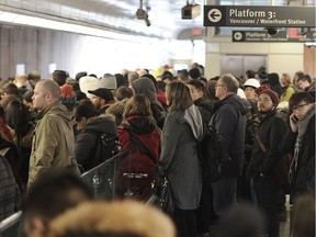 Commuters wait on packed platforms at Commercial Drive Station in Vancouver on December 5, 2016.