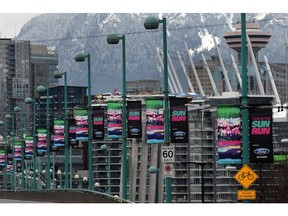 Sun Run banners decorate Cambie Street Bridge in Vancouver. Runners and walkers in the 33rd annual 10K event — set for Sunday, April 23 — will cross the bridge and finish at B.C. Place Stadium.