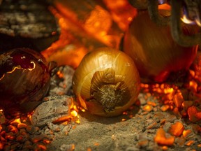 An onion getting grilled among the coals at Cincin Ristorante on Robson Street in Vancouver.