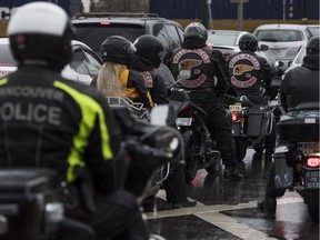 Vancouver Police watch over members of the Hells Angels during their ride from Oceanview Cemetery in Burnaby during their annual  Screwy Ride to honour the murdered friend Dave "Screwy" Schwartz in Vancouver, BC, April, 8, 2017.