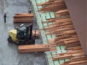 Workers sort and move lumber at the Delta Cedar Sawmill.
