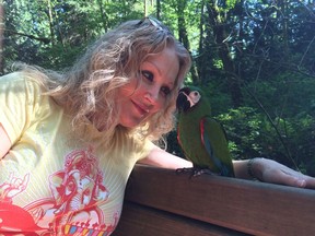 Yoga instructor Sunny Trim and Kiwi, her 21-year-old severe macaw, hanging out at the University of B.C. Endowment Lands. Kiwi was adopted by Sunny and her partner two years ago. Theirs is his third — and final, she says — home.