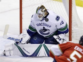 Vancouver Canucks goalie Jacob Markstrom (25) stops a shot by Florida Panthers defenseman Aaron Ekblad (5) in the second period of an NHL hockey game, Saturday, Dec. 10, 2016, in Sunrise, Fla. (AP Photo/Alan Diaz) ORG XMIT: FLAD109