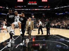 San Antonio Spurs guard Tony Parker (9) is carried off the court after being injured during the second half of Game 2 of a second-round NBA basketball playoff series against the Houston Rockets, Wednesday, May 3, 2017, in San Antonio. (Karen Warren/Houston Chronicle via AP)