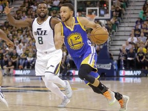 Golden State Warriors guard Stephen Curry (30) drives as Utah Jazz guard Shelvin Mack (8) defends in the first half during Game 4 of the NBA basketball second-round playoff series, Monday, May 8, 2017, in Salt Lake City. (AP Photo/Rick Bowmer)