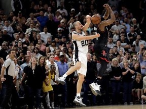 San Antonio Spurs&#039; Manu Ginobili (20) of Argentina blocks Houston Rockets&#039; James Harden three-point shot attempt in the final seconds of overtime of Game 5 in a second-round NBA basketball playoff series, Tuesday, May 9, 2017, in San Antonio. San Antonio won 110-107. (AP Photo/Eric Gay)