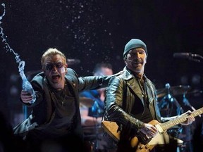 Bono, of the band U2, throws water at the crowd while the Edge looks on as they perform in the band&#039;s first concert of their new world tour in Vancouver on May, 14, 2015. Legendary rockers U2 have clearly found what they&#039;re looking for in Vancouver. The famed Irish band is drawing plenty of local attention with a return to the city for the launch of the 30th anniversary &ampquot;Joshua Tree&ampquot; tour on Friday. It&#039;s the second time they&#039;ve picked Vancity as the starting mark for a tour -- it was almost exac