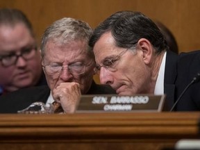 FILE - In this Jan. 18, 2017 file photo, Senate Environment and Public Works Committee Chairman Sen. John Barrasso, R-Wyo., right, confers with Sen. James Inhofe, R-Okla. on Capitol Hill in Washington, during the committee&#039;s confirmation hearing for Environmental Protection Agency Administrator-designate, Oklahoma Attorney General Scott Pruitt. Republicans anxious to show they&#039;ve done something point to the reversal of more than a dozen Obama-era regulation on guns, the internet and the environm